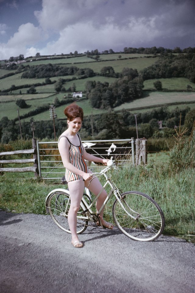 Taking a quick break on the side of a country road, this woman is on her way to the beach