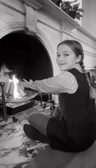  Harper kept herself warm by the fire