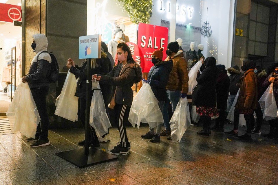 In Liverpool, shop staff set up hand sanitising stations to keep customers safe 