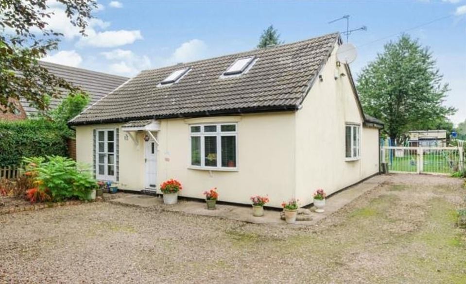 In the South Yorkshire village of Hatfield Woodhouse, this two-bedroom detached cottage comes with a large garden with outbuildings