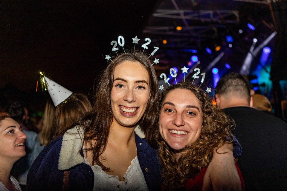 Sophie Jackson and Monique Lee, both from Christchurch, attend New Year celebrations in Hagley Park