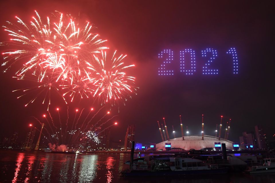 Fireworks and drones illuminate the night sky over London
