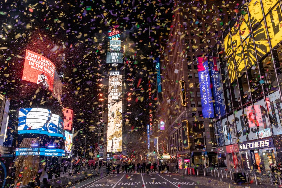 Confetti flies around the ball and countdown clock in Times Square, New York
