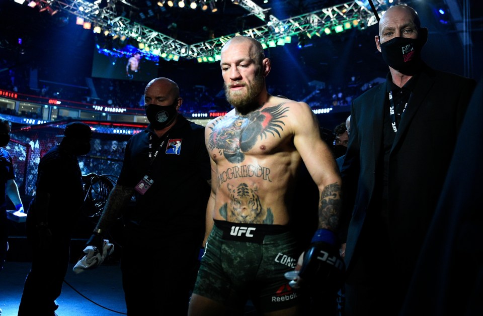 A dejected Conor McGregor leaves the Etihad Arena after his stoppage loss to Dustin Poirier