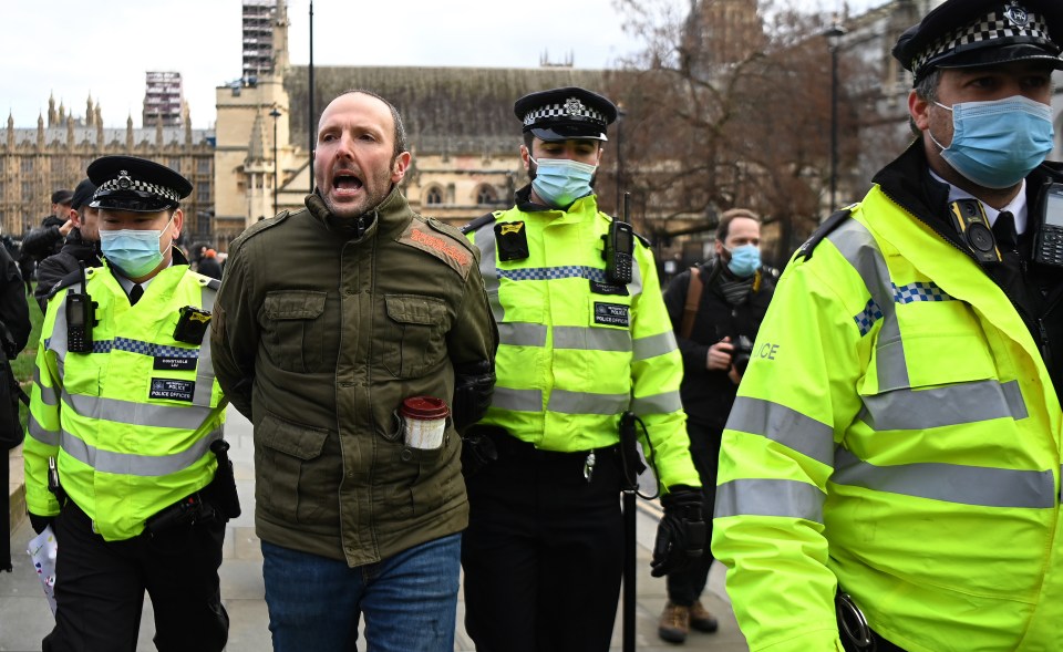 Scotland Yard officers today arrested protesters in central London