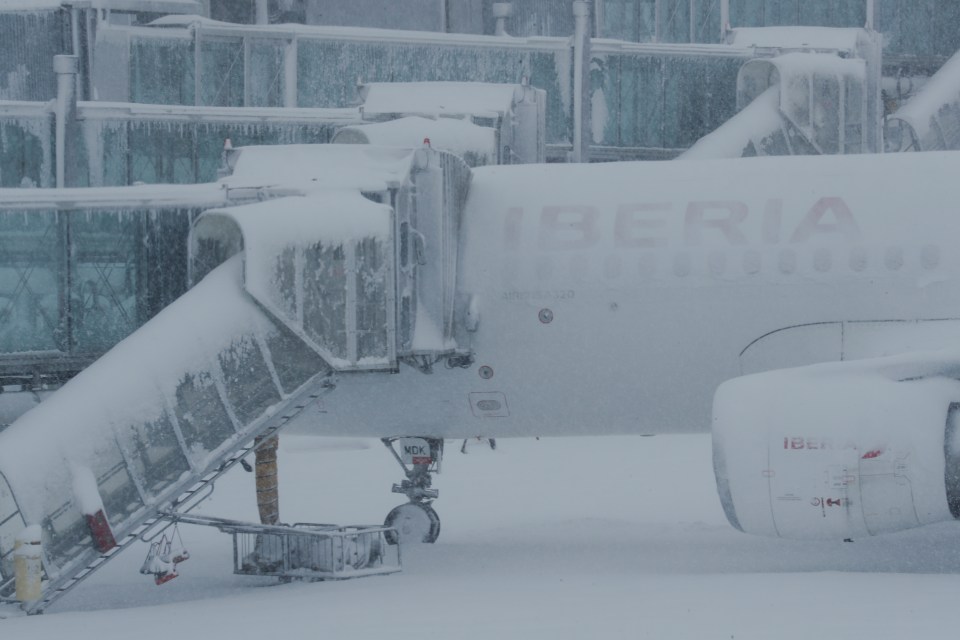 One of the passenger jets left covered in snow in the Spanish capital