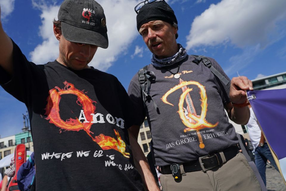 Q supporters wear clothing inspired by the conspiracy theories