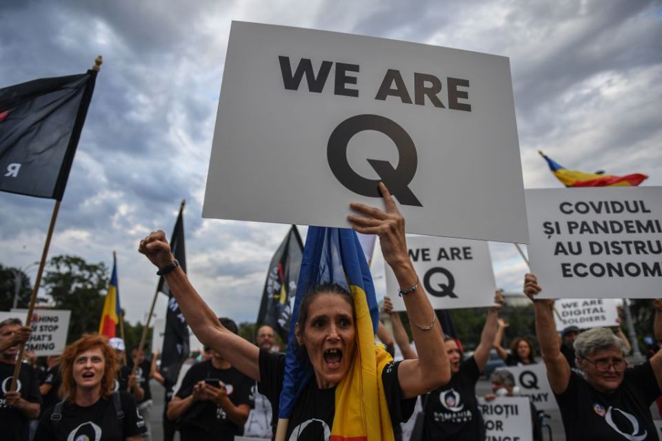 QAnon supporters rally in front of the headquarters of the Romanian Government