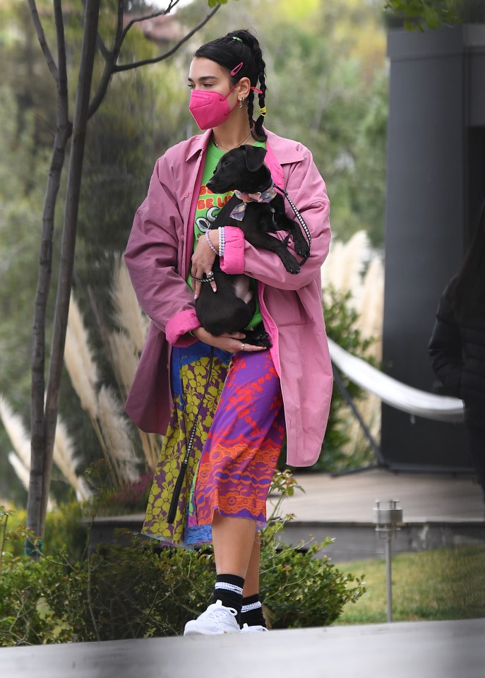 Dua hugged her puppy close to her chest