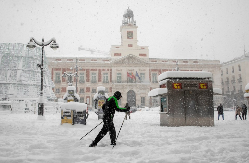 A man skis through  Puerta del Sol Square in Madrid