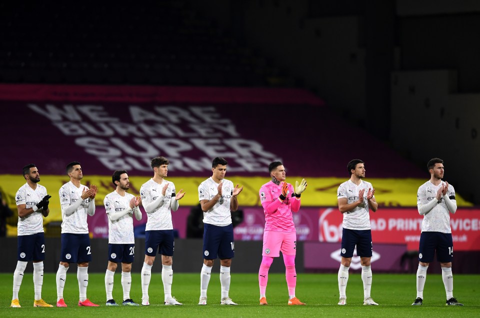 Players of Manchester City take part in a minutes applause in memory of Sir Captain Tom Moore