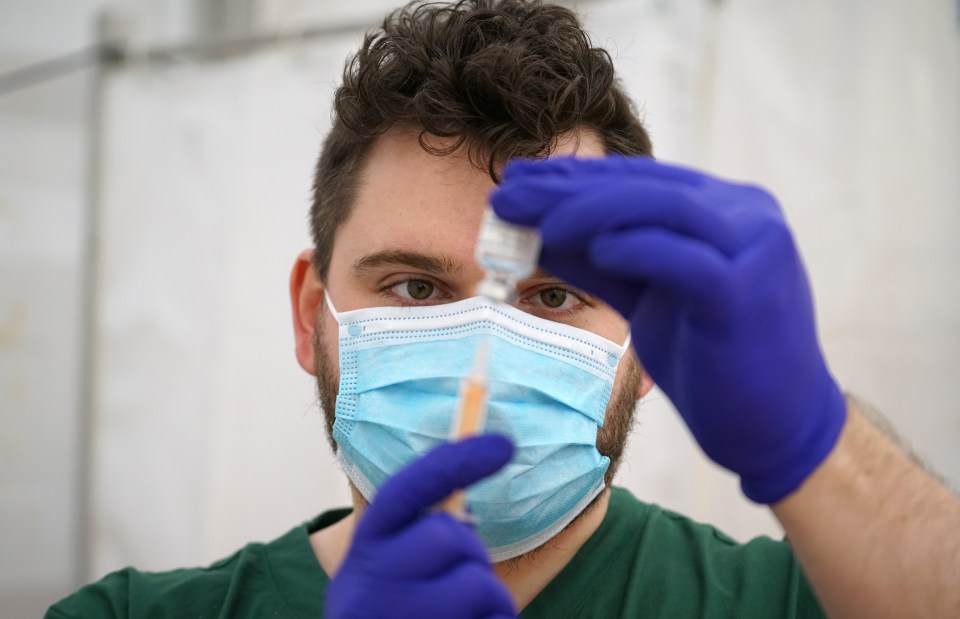 NHS Pharmacist Matthew Greening prepares doses of the AstraZeneca/Oxford Covid-19 vaccination