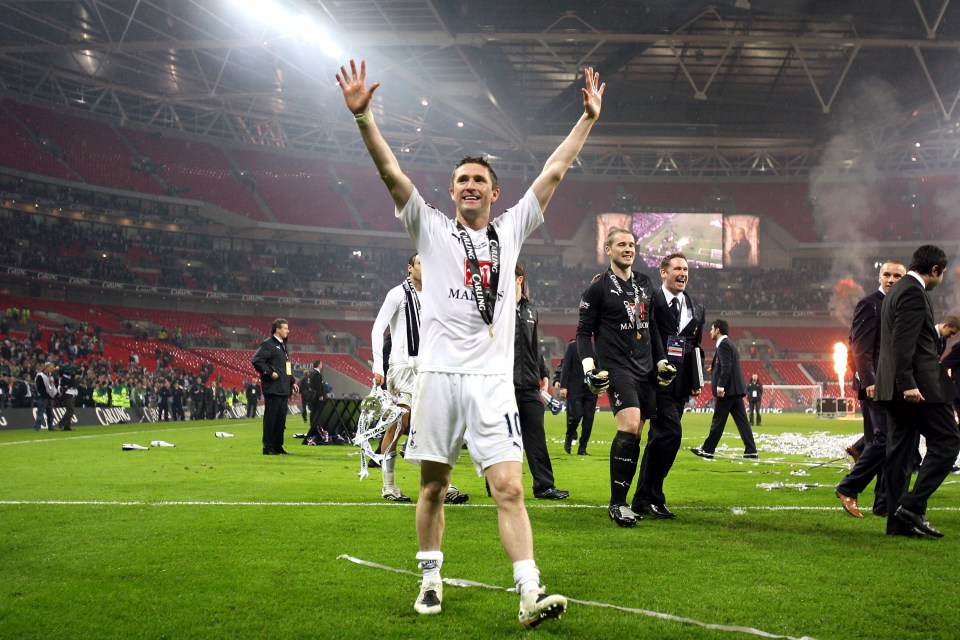 Robbie Keane celebrates at Wembley with his winner's medal around his neck