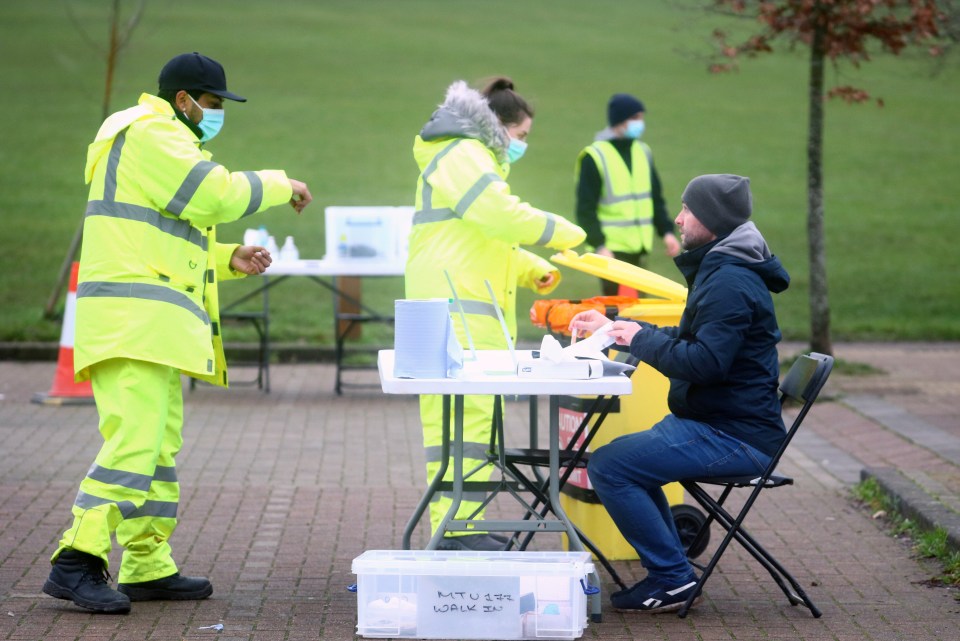 A man is seen taking a swab test near Woking in Surrey