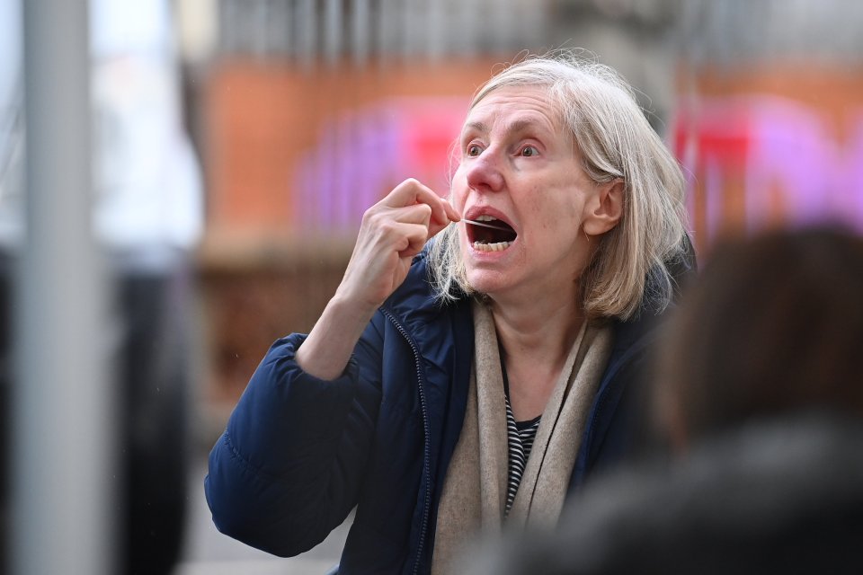 A member of the public is seen carrying out a test at a new Variant Testing Centre in Ealing, West London