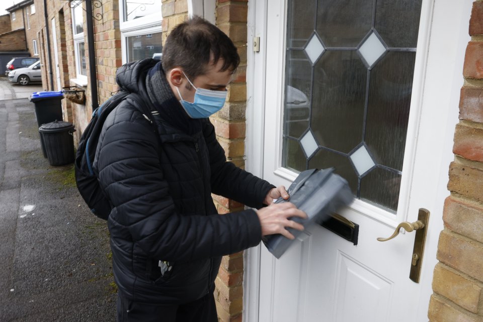 Volunteers were seen distributing test kits this morning in Surrey through letter boxes after ministers urged residents to not leave their homes