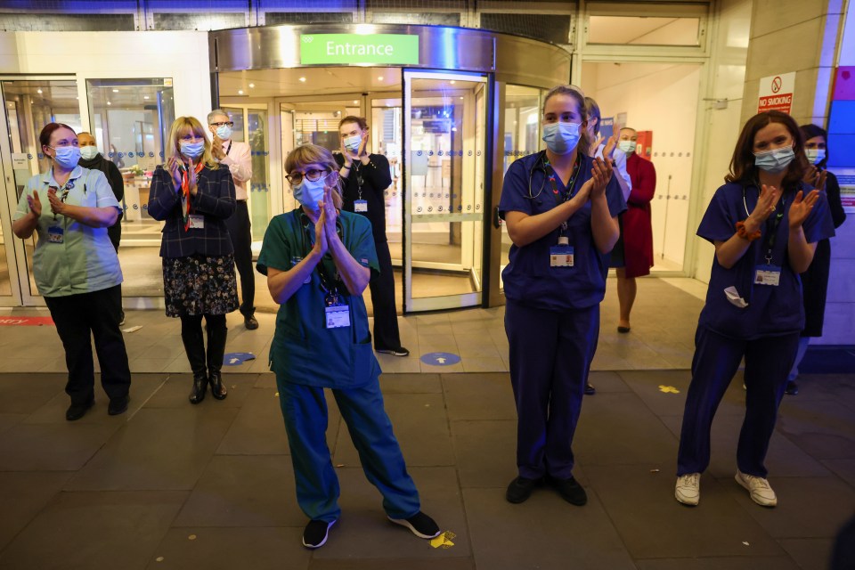 NHS staff participate in a national clap for late Captain Sir Tom Moore at Chelsea and Westminster Hospital in London