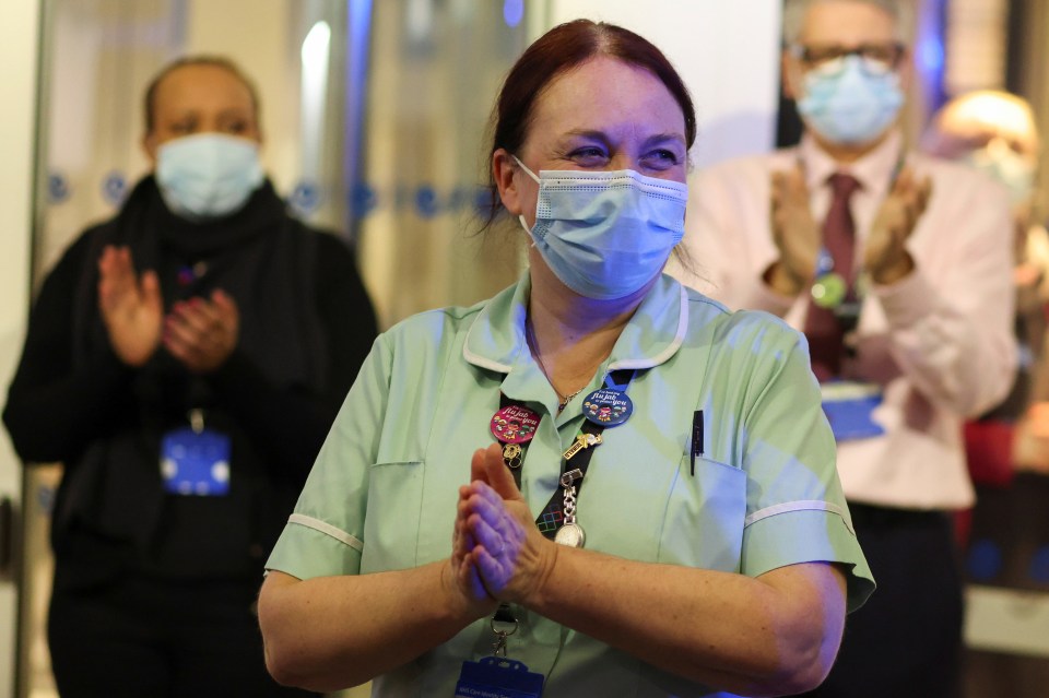 An NHS worker at Chelsea and Westminster Hospital in London claps for Captain Sir Tom Moore