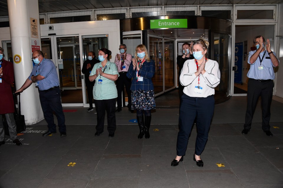 Doctors, nurses and health workers step out of the Chelsea and Westminster Hospital to clap