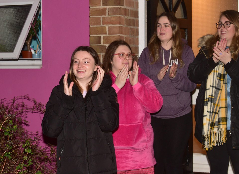 A group of university students from Brighton join in the national moment of applause 