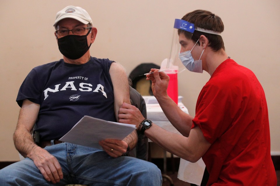 More than 65 million Covid vaccine doses have been given in the US. Pictured: A man receives his first dose of Pfizer's vaccine in New York, February 23