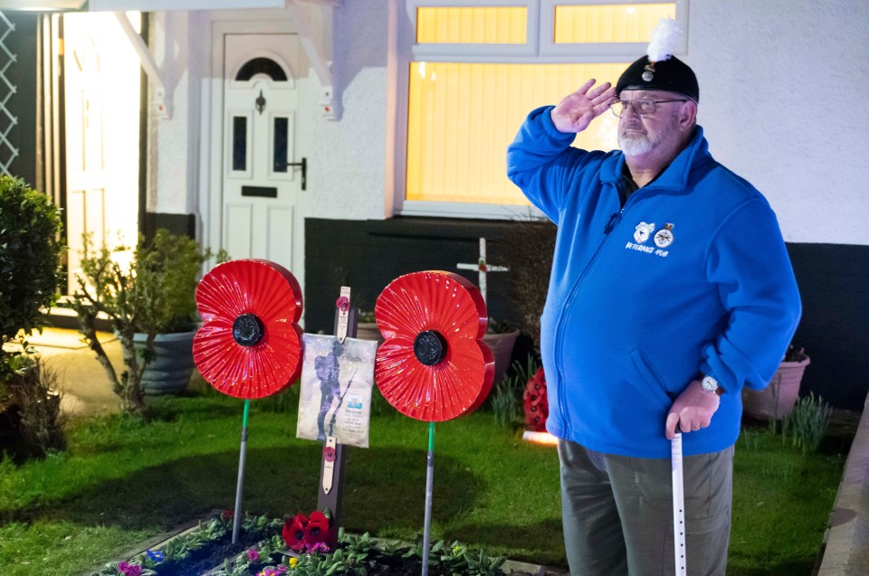 Melvyn Burlace salutes Captain Tom in his front garden in Cardiff, Wales