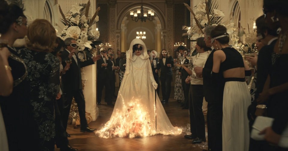 Her white cloak suddenly turns into a striking red dress