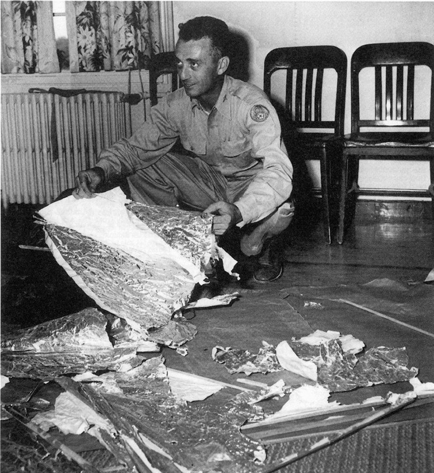 Major Jesse Marcel shows of wreckage from the Roswell 'UFO' crash in 1947