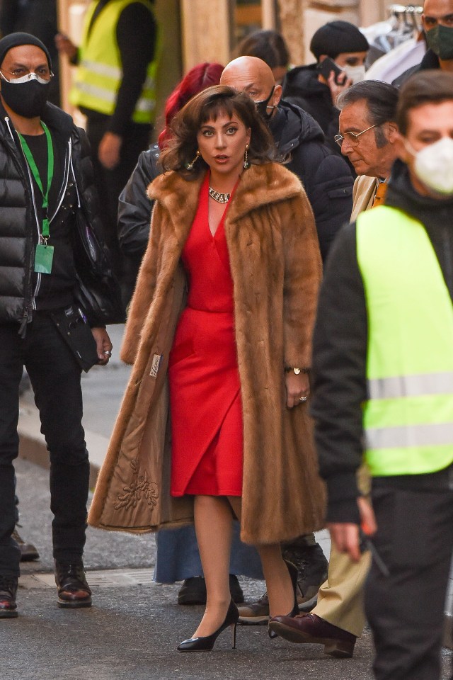 Lady Gaga looked phenomenal in a red dress and fur coat on the set of House Of Gucci
