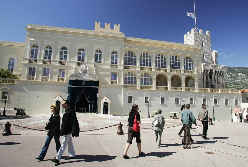 Tourists view the main entrance of the Monaco palace
