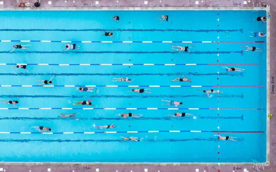 Swimmers exercise at Hampton outdoor pool in south west London