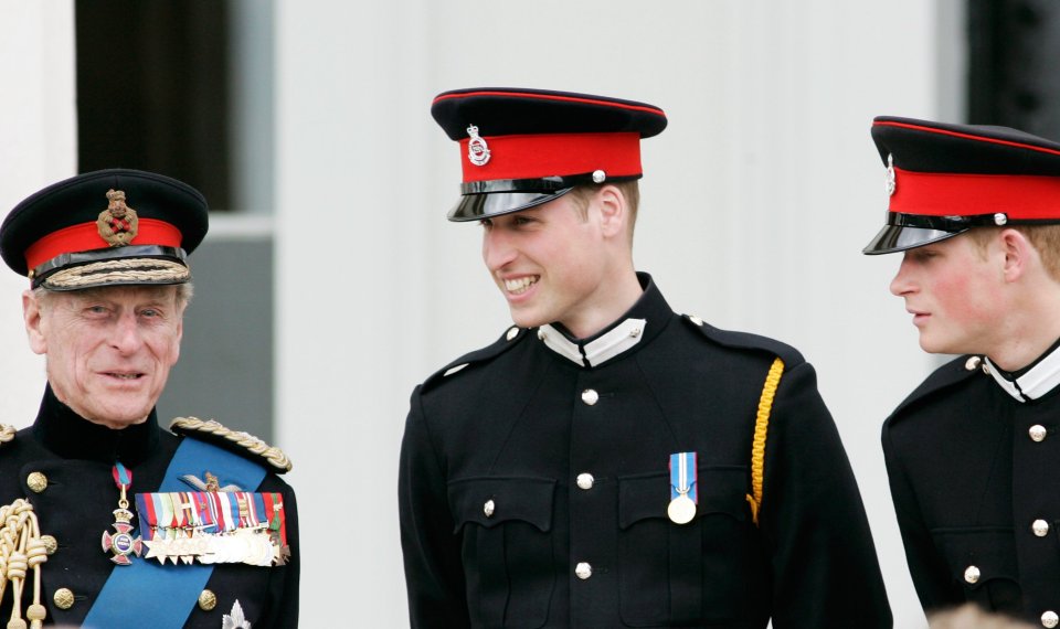 The Duke of Edinburgh chats with his grandsons Prince William and Prince Harry at the Sovereign's Parade at Sandhurst Military Academy