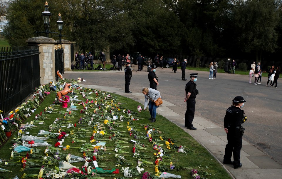 Police standing in front of the floral tributes as Windsor on Friday