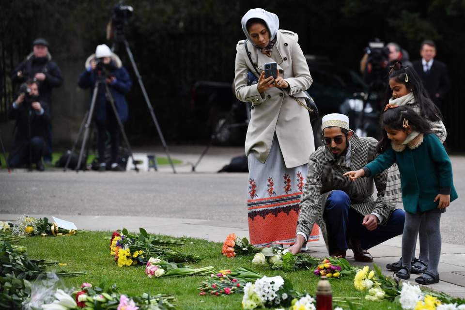 A family arrives to lay flowers at Windsor Castle