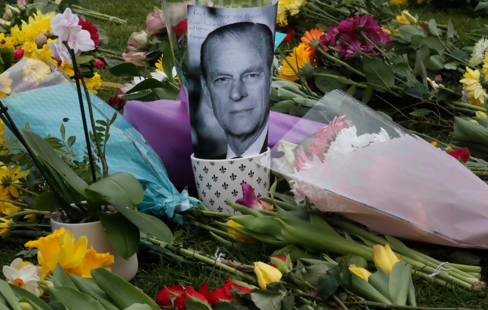 A picture of the late Prince left among the flowers in Windsor