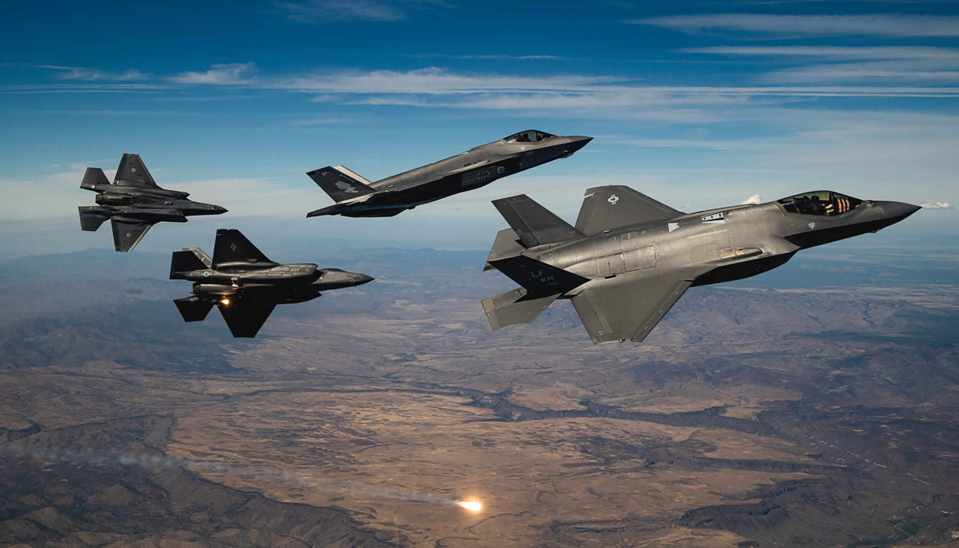 Two US Air Force and two Royal Australian Air Force F-35A Lightning II break formation during a commemoration flight