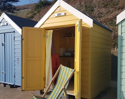 Inside this hut there is a camping stove, table and chairs for six, bodyboards and beach games