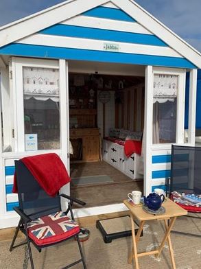 This quintessential striped beach hut is on the promenade, right next to Southwold Pier