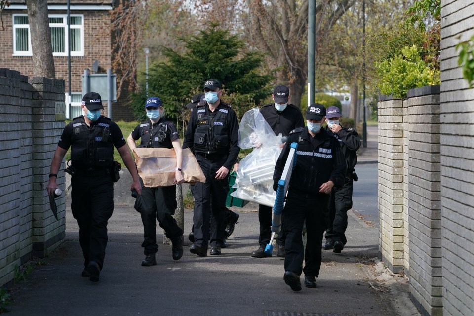 Officers were seen searching the suspect's home today