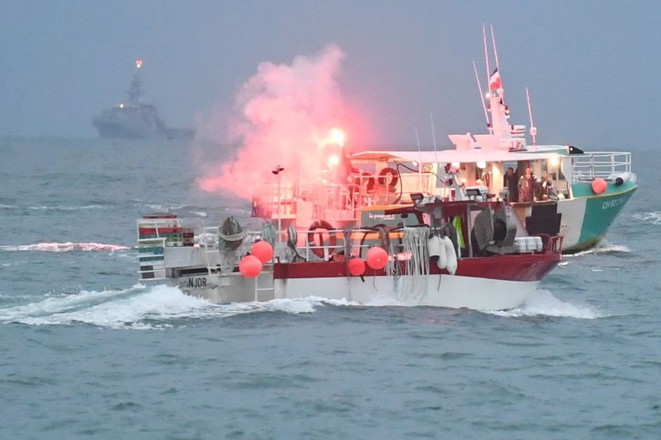 People on board the vessels were seen setting off flares as tensions continued to rise this morning - with the Royal Navy lurking in the background