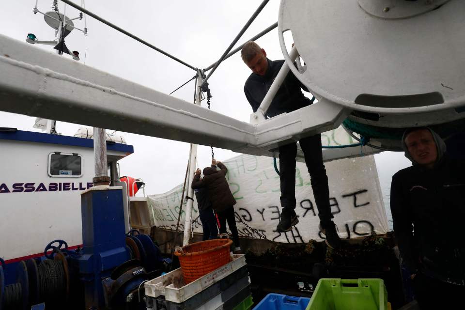 French fishermen hang a banner as fishing boats protest  near Jersey
