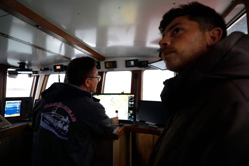 French fishermen protest on their boat in front of the port of Saint Helier