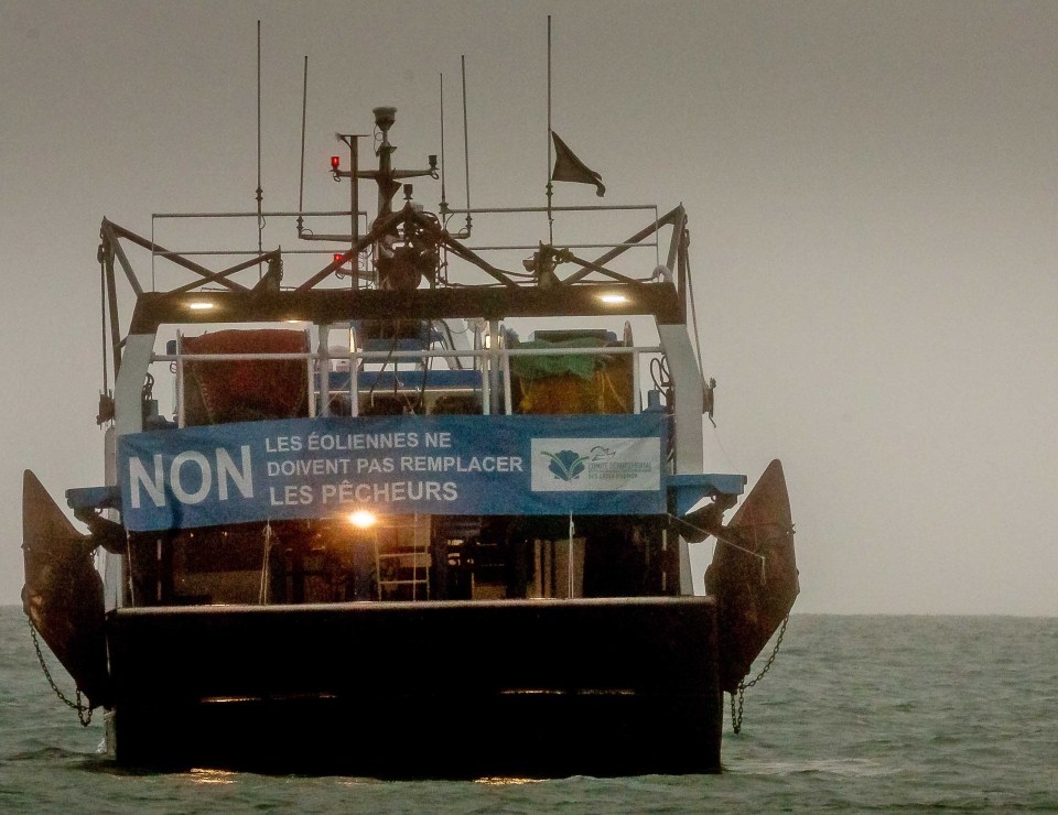 A French fishing boat displays a protest sign opposing new fishing licenses during today's stand-off
