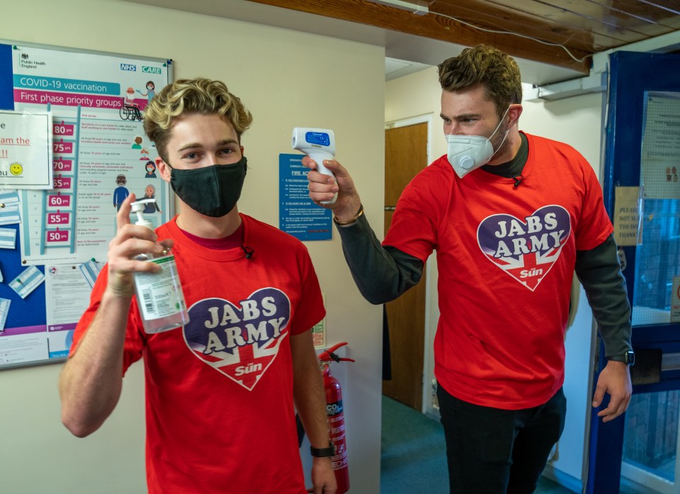 AJ wields a hand gel while Curtis aims thermometer