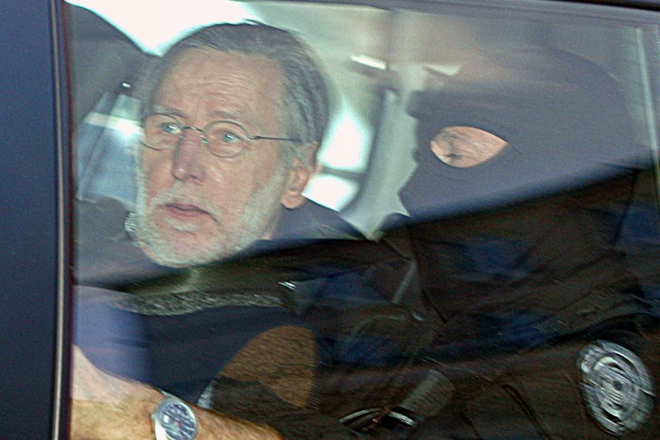The self-confessed serial killer arrives in a police car to attend his trial in 2008