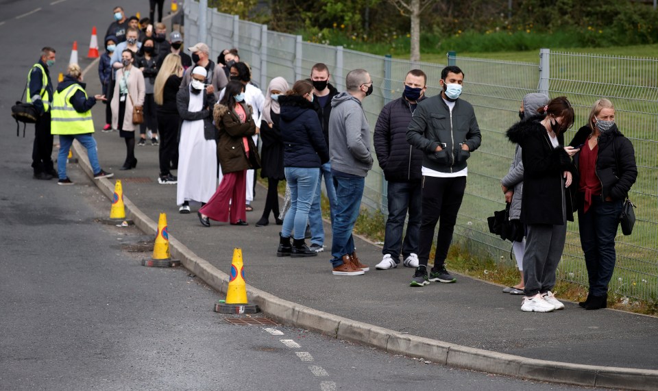 People queue up for a vaccine in Bolton, one of the areas affected