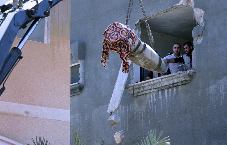 Hamas explosive experts remove an unexploded Israeli missile from a house in Khan Yunis