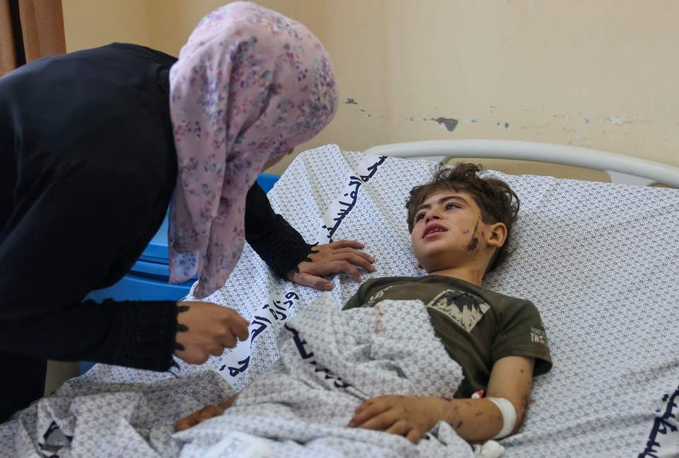 A Palestinian boy injured in an Israeli airstrike lies in hospital