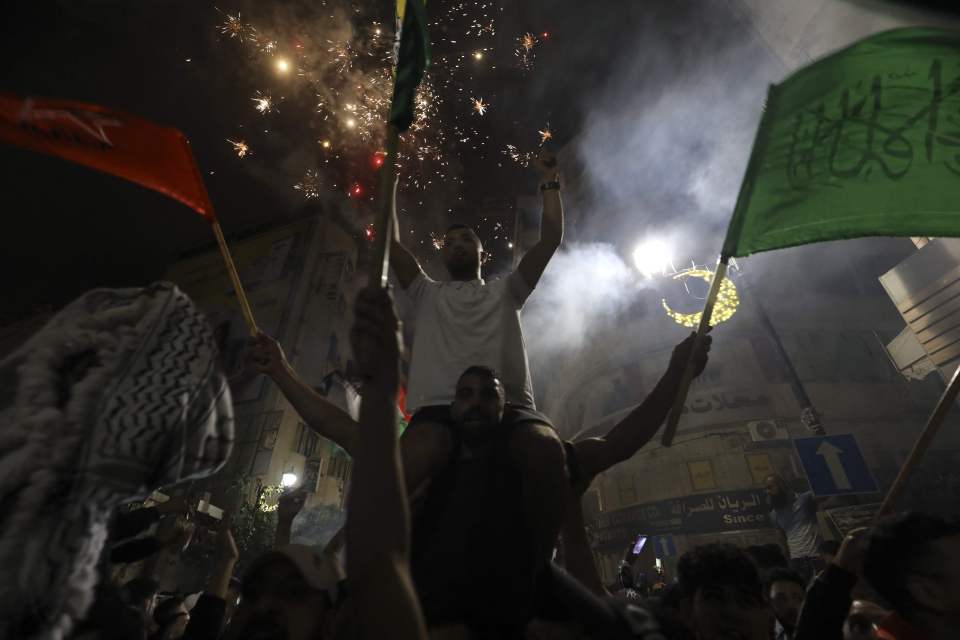 Smoke fills the air from fireworks in the packed streets of Gaza