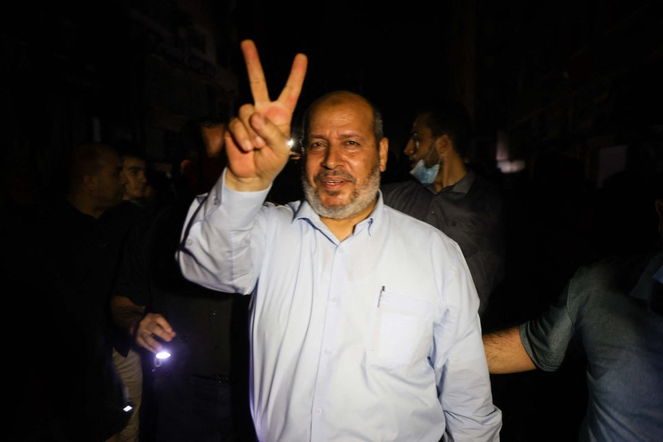 Hamas leader Khalil al-Haya flashes the V-sign for victory as people take to the streets to celebrate the ceasefire brokered by Egypt